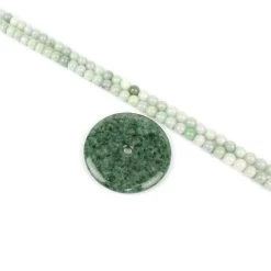 255cts Type A Green Jadeite Huaigu Approx 58mm With 489cts Green Jadeite Plain Rounds Approx 8mm, 84cm Strand